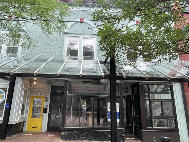 Exterior of a retail space for rent at 140 Church Street in Burlington, Vermont with a glass awning and large exterior windows on the storefront.